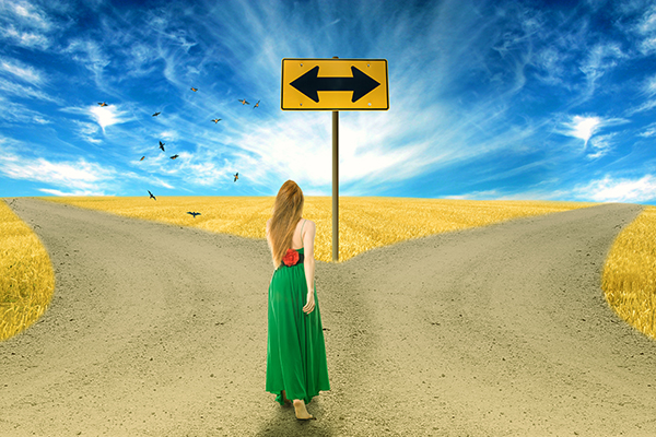 Young woman standing in front of two roads