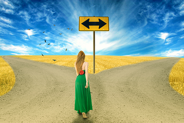 Young woman standing in front of two roads